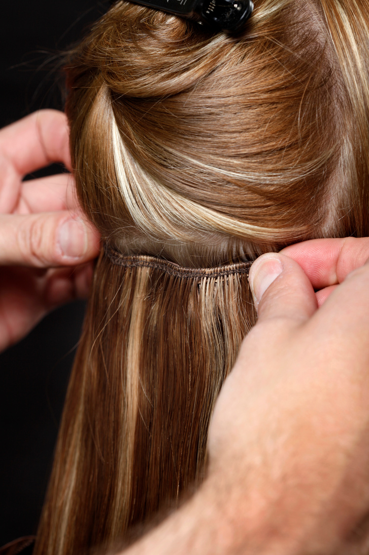 Hairstylist Putting in Hair Extensions